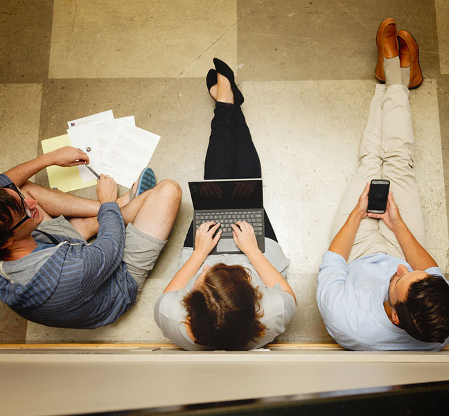 aerial view of marketing coworkers with laptop and paper on floor